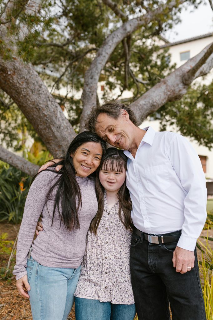 Loving family enjoying a moment together in an outdoor park setting. Smiling and happy.